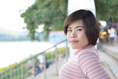 Portrait of young woman against blurred background