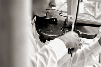 Close-up portrait of young woman playing guitar