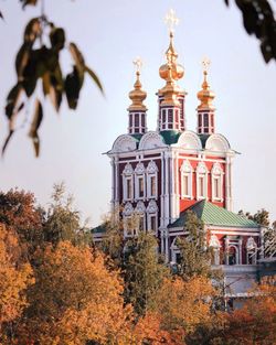 Low angle view of novodevichy convent by trees against sky