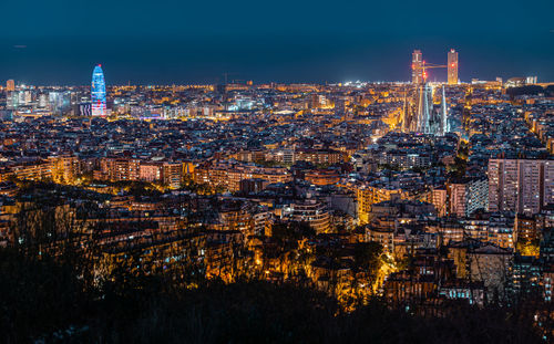 High angle view of city lit up at night