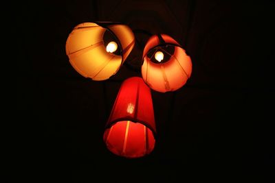 Low angle view of illuminated lantern against black background