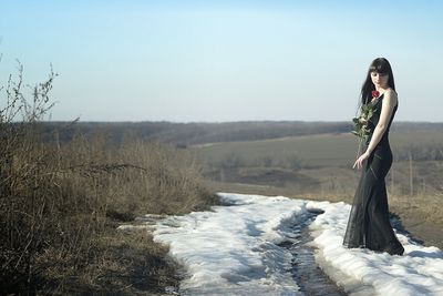 Silhouette of woman against clear sky