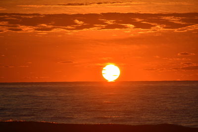 Scenic view of sea against romantic sky at sunset