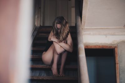 Young woman standing in corridor