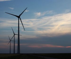 Low angle view of windmill against sky during sunset