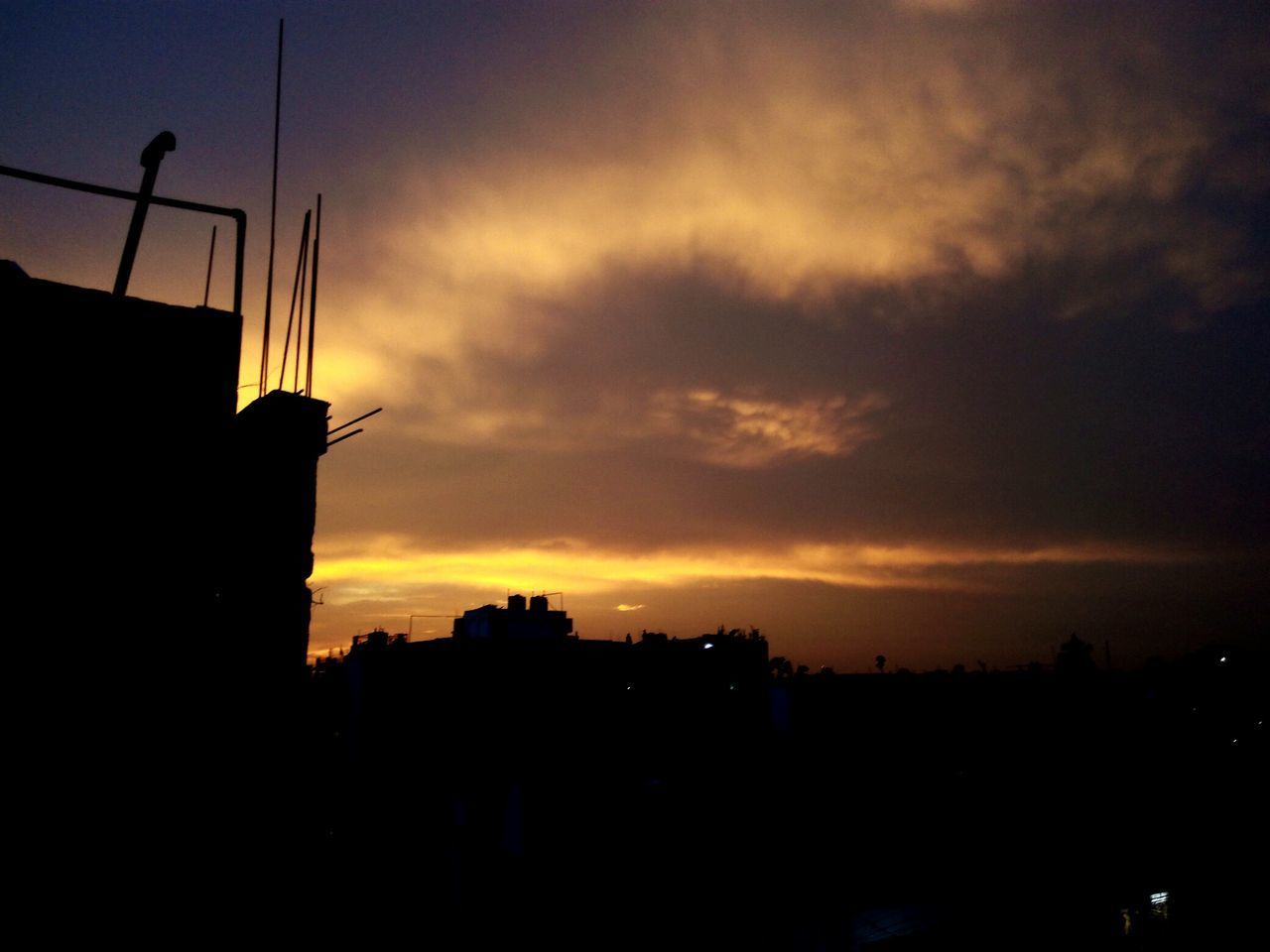 SILHOUETTE BUILDINGS AGAINST SKY DURING SUNSET