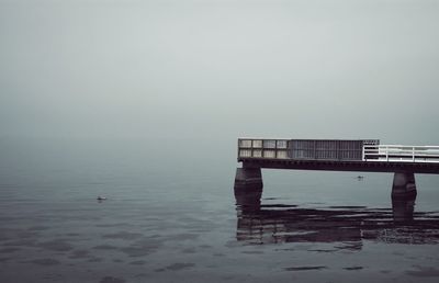 Bridge over sea against sky