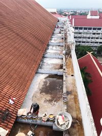 High angle view of houses amidst buildings in city