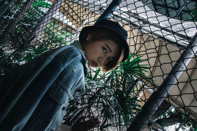 Portrait of girl with plants against trees