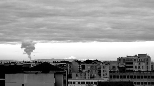 Smoke emitting from chimney against sky