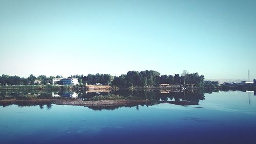 Scenic view of lake against clear blue sky