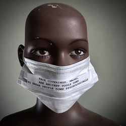Close-up portrait of a teenage girl against blue background