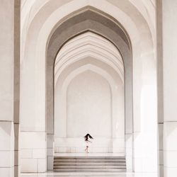 Woman in corridor of historic building
