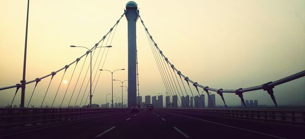 Bridge over river at sunset