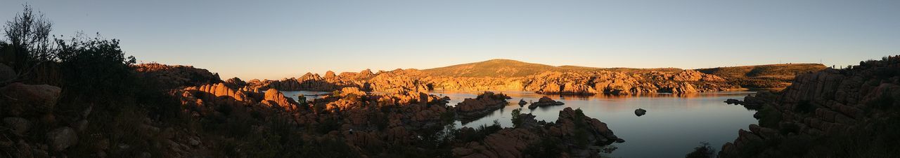 Panoramic view of rocks and trees against clear sky