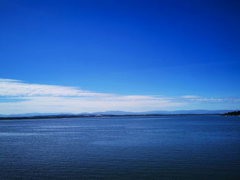 Scenic view of sea against blue sky