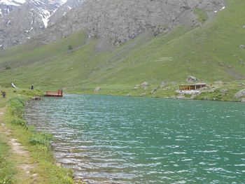 Scenic view of river with mountains in background