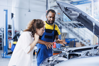 Portrait of young woman standing in factory