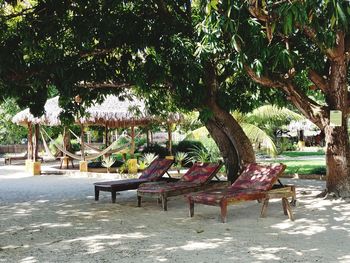 Empty chairs and table in park