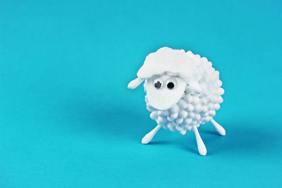 Close-up of white toy against blue background