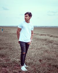 Full length of young man standing on land