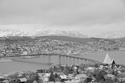 High angle view of townscape by river against sky