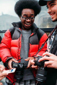 Portrait of smiling woman photographing