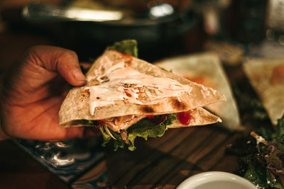 Cropped hand of person preparing food