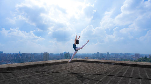 Ballerina dancing on building terrace