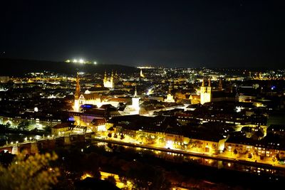 High angle view of illuminated buildings against sky at night