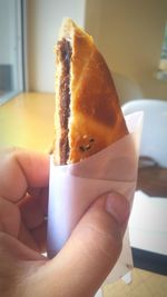 Close-up of cropped hand holding coffee