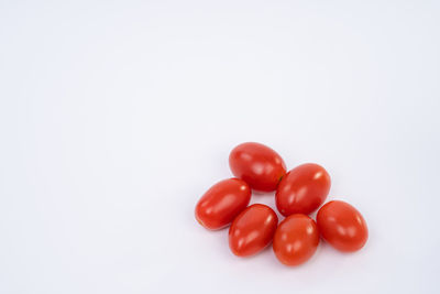 Close-up of tomatoes over white background