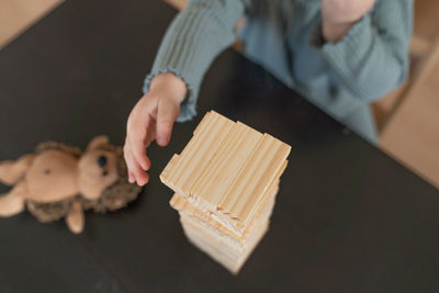 Midsection of man holding toy blocks