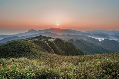 Scenic view of mountains against sky during sunset