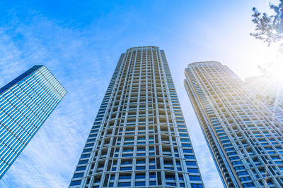 Low angle view of modern buildings against blue sky