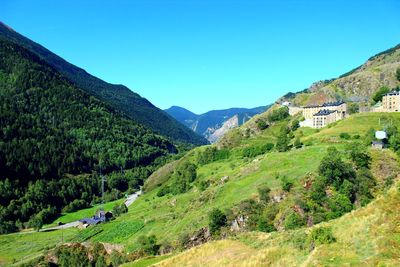 Scenic view of mountains against clear blue sky