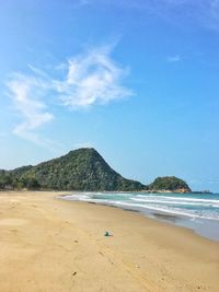 Scenic view of beach against blue sky