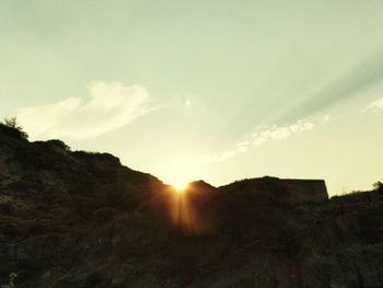 Silhouette landscape against sky during sunset