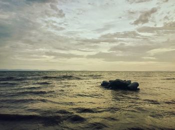 Scenic view of sea against cloudy sky