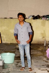 Portrait of smiling young man standing on floor