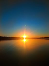 Scenic view of sea against clear sky during sunset