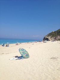 Scenic view of beach against blue sky