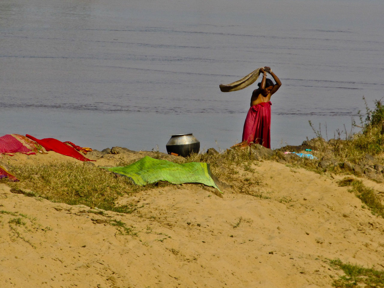 REAR VIEW OF WOMAN WITH UMBRELLA ON BEACH