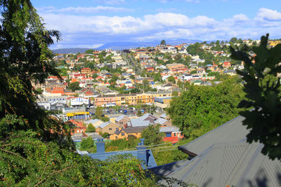 High angle view of houses in town against sky