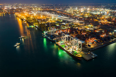 High angle view of commercial dock and shopping containers at night 