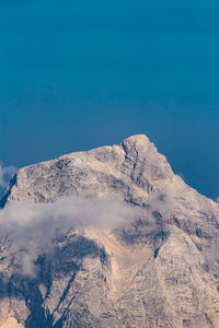 Scenic view of snowcapped mountains against blue sky