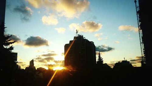 Low angle view of buildings against sky at sunset