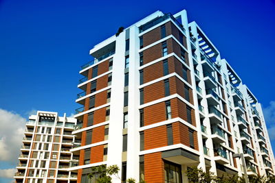 Low angle view of modern building against clear blue sky