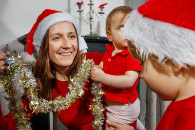 Portrait of woman holding christmas tree