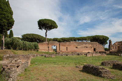 Old ruins on field against sky